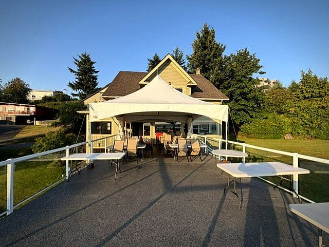 The deck set with a marquee and dining tables, ready for an event